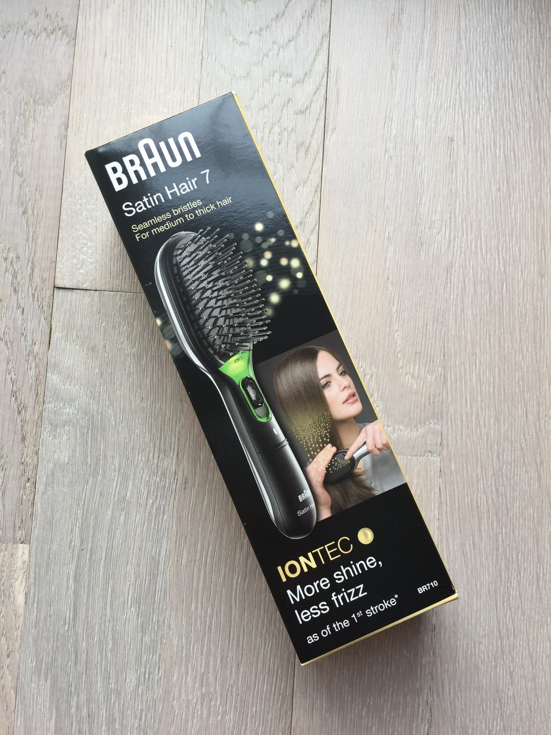 Boîte de la brosse Braun Satin Hair 7 IONTEC noir et vert, avec illustration d'une brosse ionisante et d'une femme aux cheveux lisses