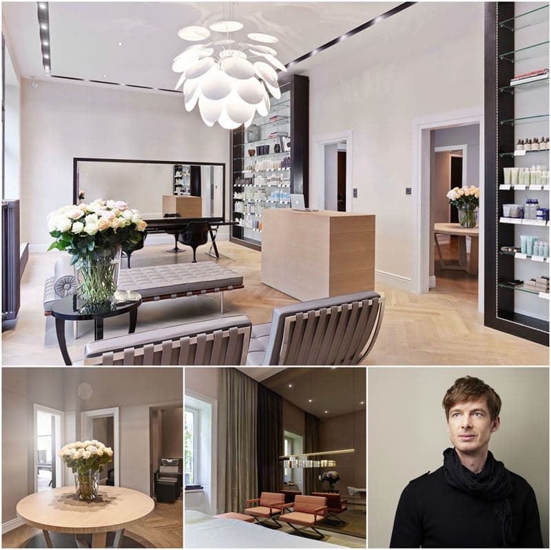 Intérieur du salon de coiffure Reto Holzer à Zurich avec lustre design, comptoir en bois clair, miroir, fleurs blanches et homme aux cheveux clairsemés