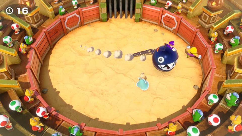 Super Mario Party, plateau de jeu avec une arène circulaire en sable, personnages et Bullet Bill mauve au centre, Toads colorés en périphérie
