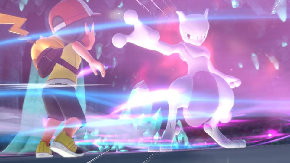 Deux Pokémon se battent avec des attaques lumineuses roses et bleues dans Pokémon Let's Go