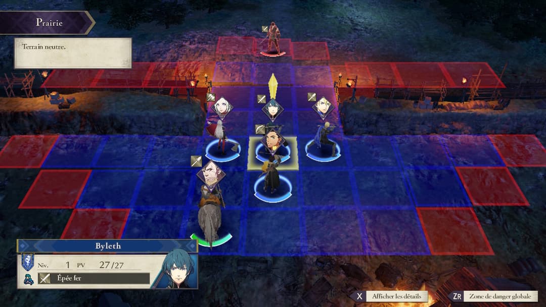 Capture d'écran de Fire Emblem: Three Houses montrant un champ de bataille en prairie avec des unités positionnées sur une grille tactique rouge et bleue