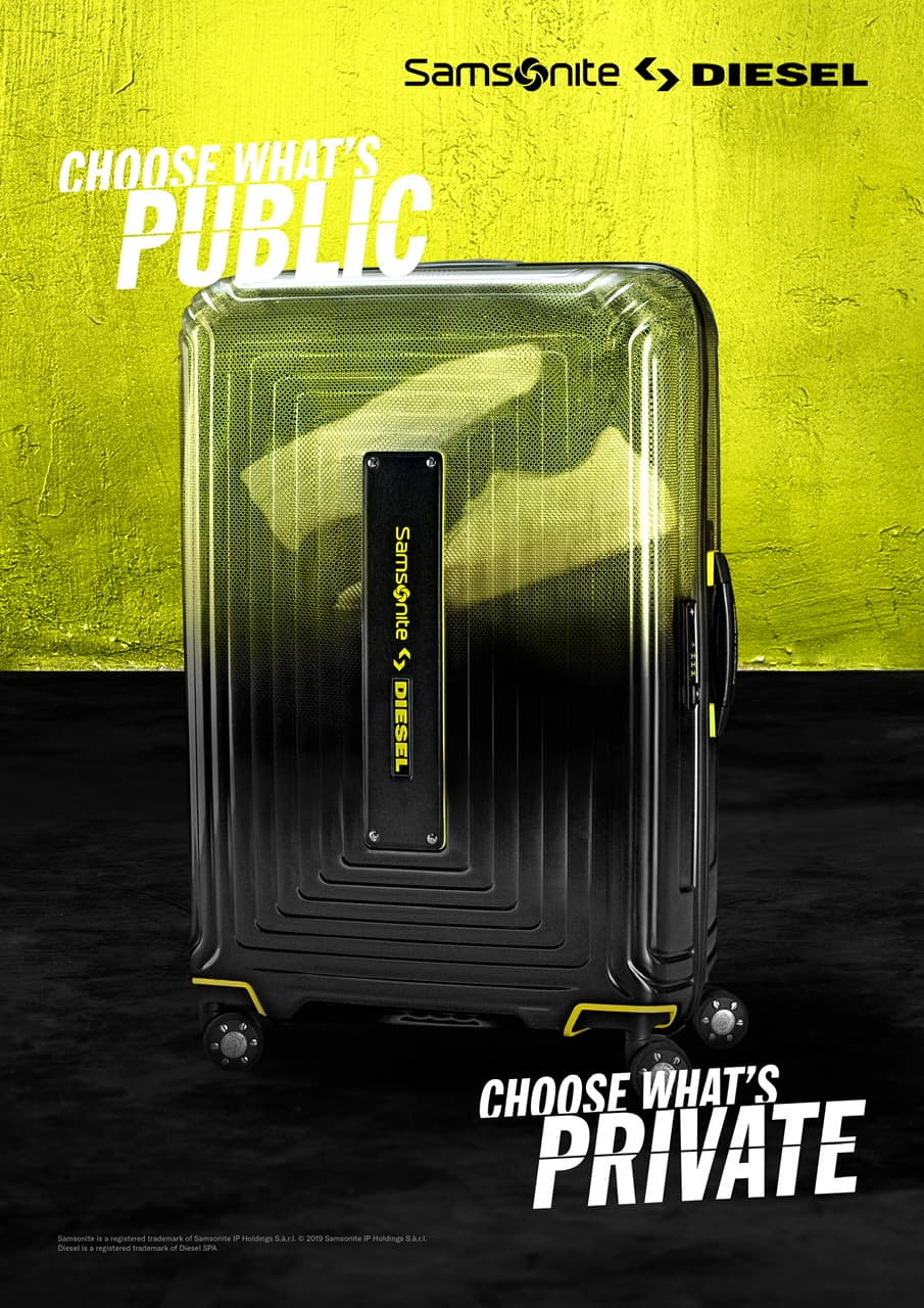 Valise Samsonite Diesel noire et jaune avec roulettes doubles et logo Diesel, sur fond jaune fluo