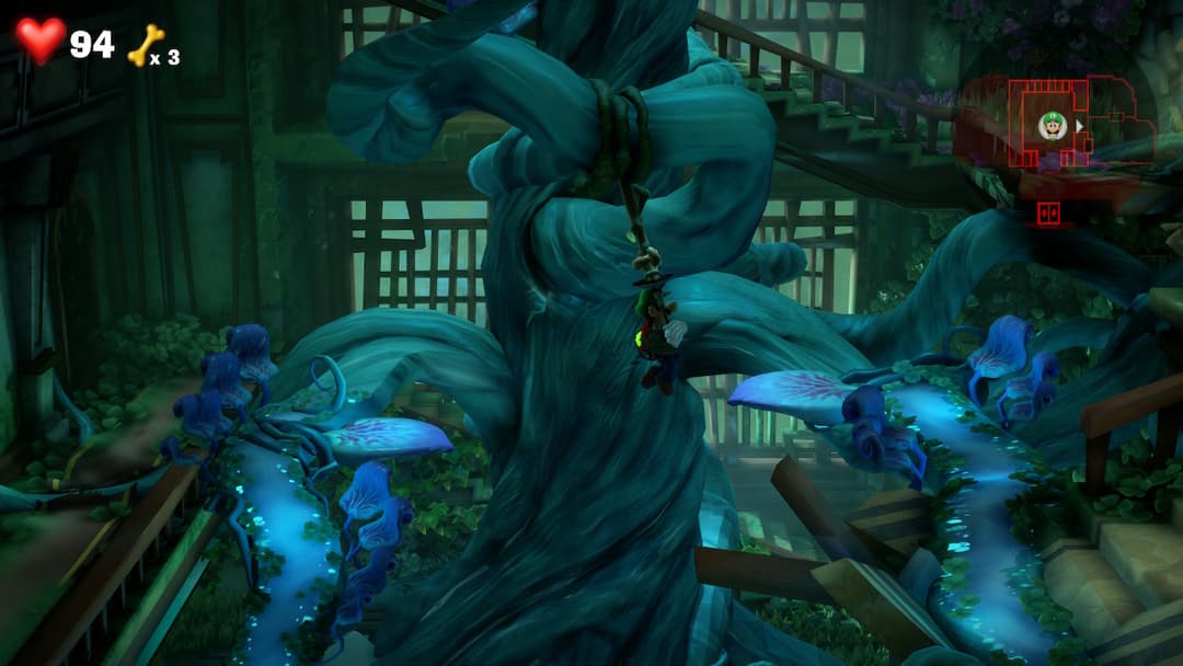Luigi et ses clones bleus affrontant un spectre géant dans une salle de mansion aux teintes vertes et bleues