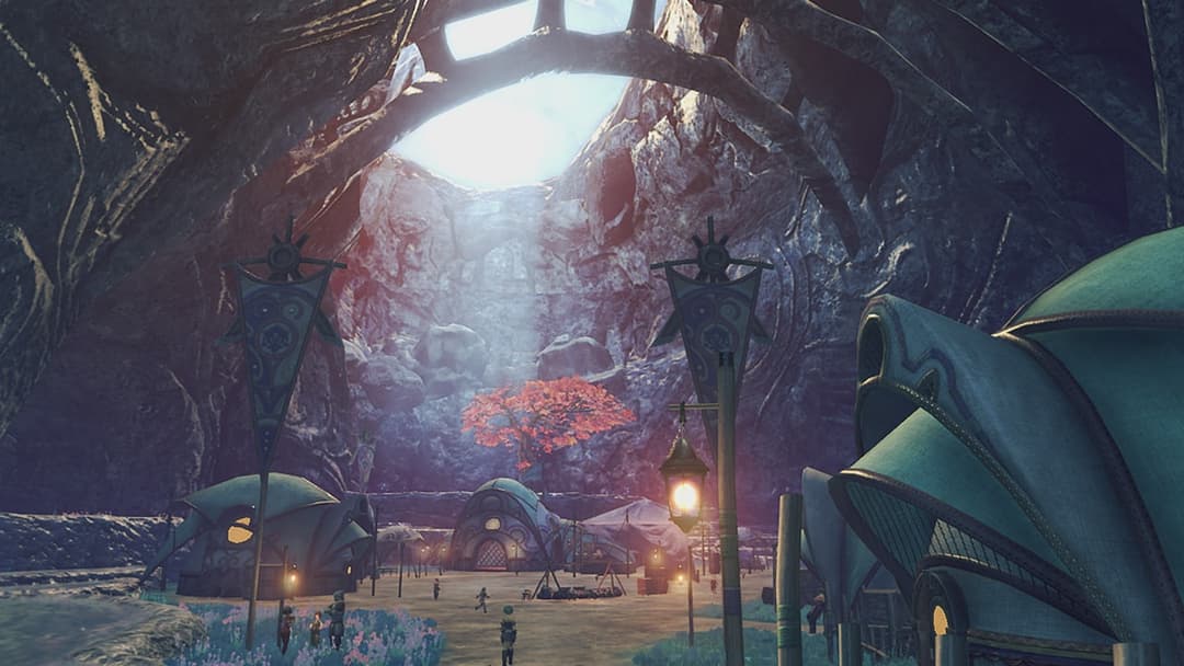 Ville futuriste souterraine de Xenoblade Chronicles 2 avec bâtiments arrondis bleus, lampadaires stylisés et montagne rocheuse illuminée en arrière-plan
