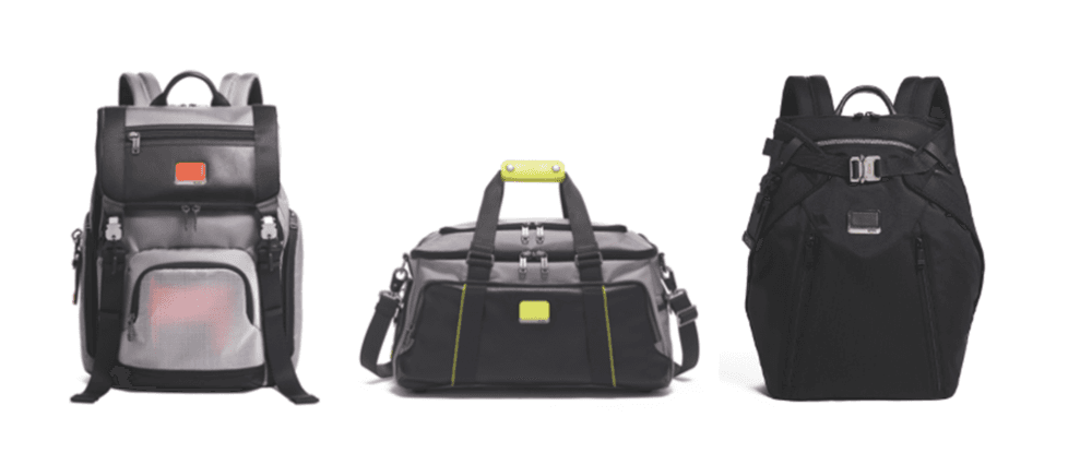 Trois sacs de voyage TUMI : un sac à dos noir et gris avec détails orange, un sac de sport noir et gris avec accents jaune citron, et un sac à dos noir avec fermetures métalliques