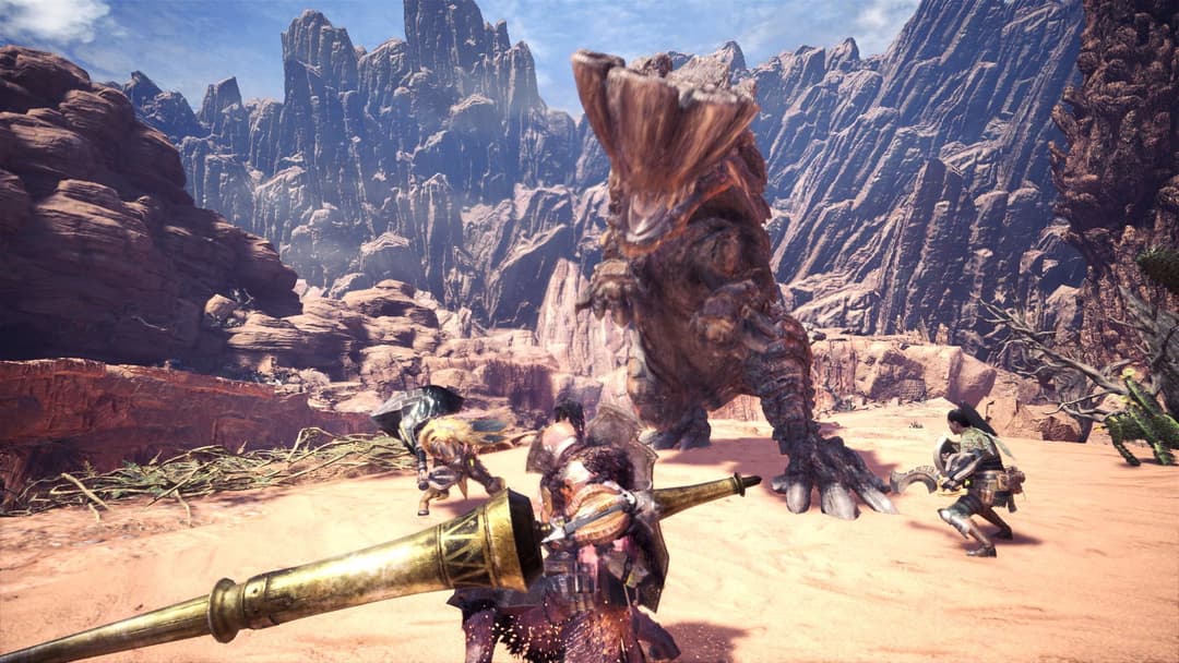 Chasseur armé d'une épée affrontant un monstre géant dans un paysage désertique rocheux dans Monster Hunter World