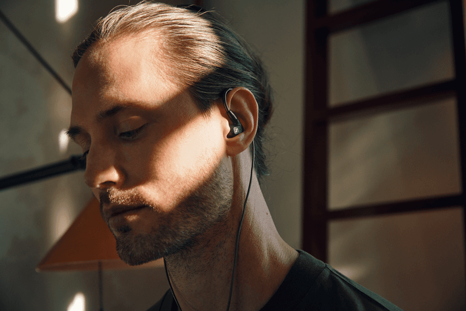 Écouteurs intra-auriculaires Sennheiser IE 300 portés par un homme avec un câble visible