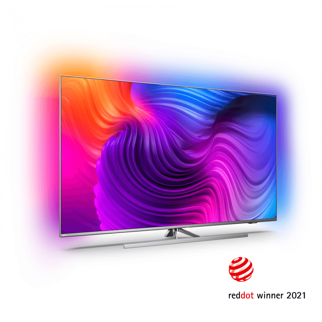 Téléviseur Philips OLED806 avec un motif ondulé multicolore sur l'écran, reposant sur un support blanc et bande rouge du logo Red Dot Award 2021