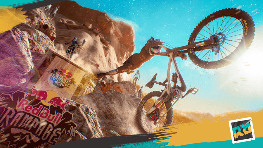 Riders Republic, jeu de sport en monde ouvert montrant un cycliste en suspension effectuant un trick aérien sur un désert ocre avec logos Red Bull