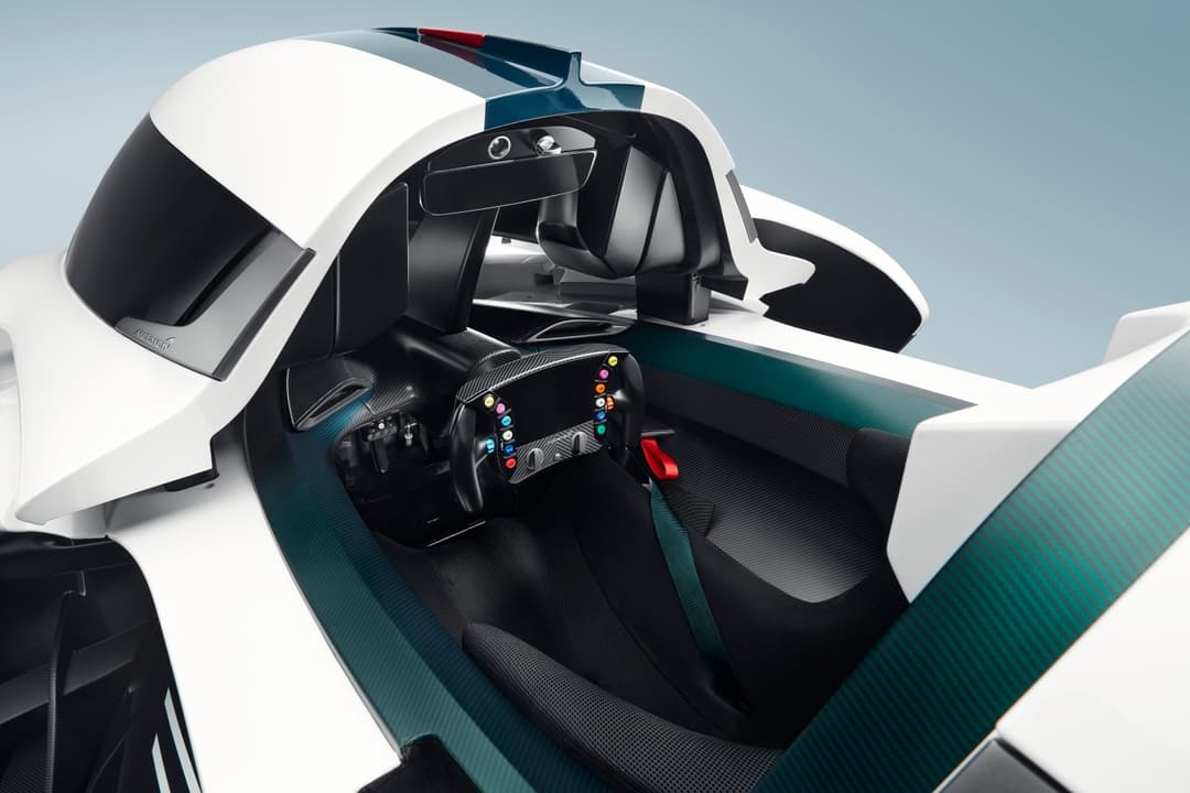 Cockpit minimaliste de la McLaren Solus GT avec siège unique, volant de course et pédalier réglable dans habitacle noir et vert