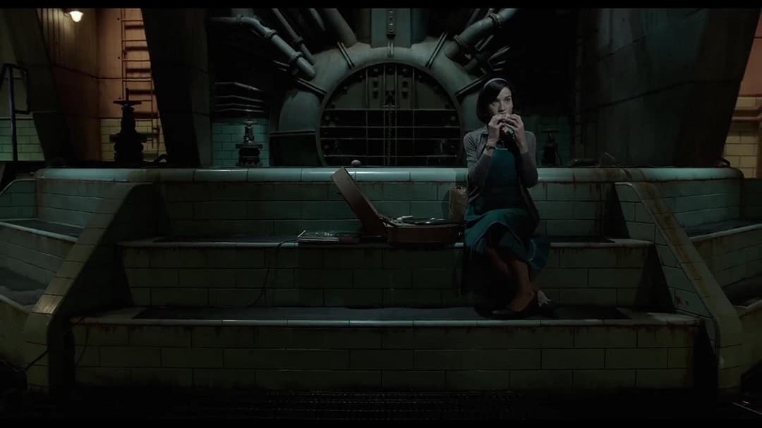 Femme assise dans un bassin carrelé d'un laboratoire aux couloirs aseptisés et teintes vertes, dans The Shape of Water