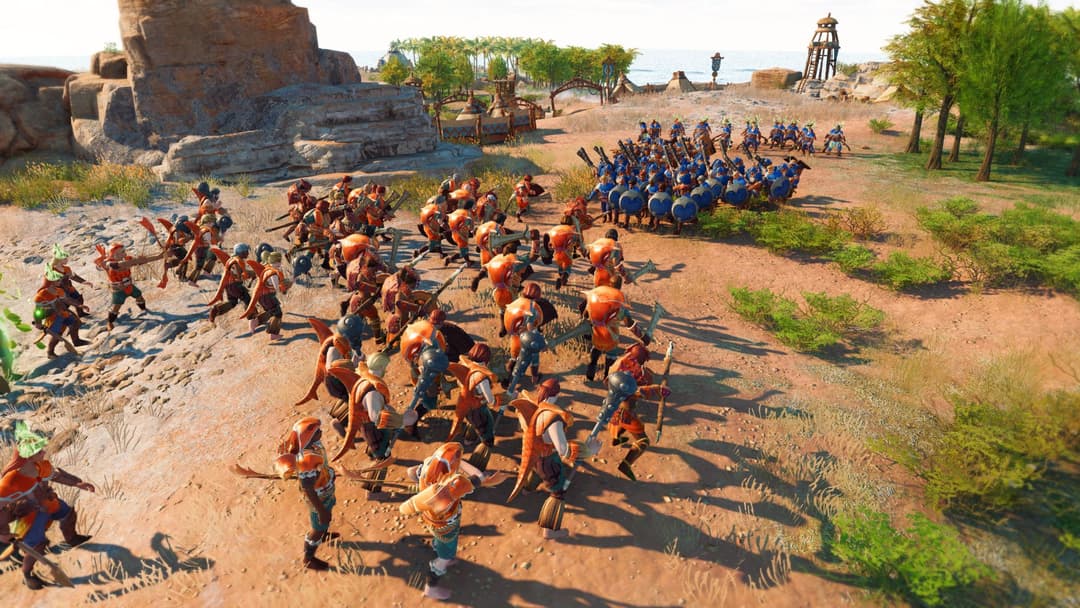 The Settlers: New Allies montrant deux armées de guerriers en tenues oranges et bleues s'affrontant dans un paysage désertique avec bâtiments et structures de jeu