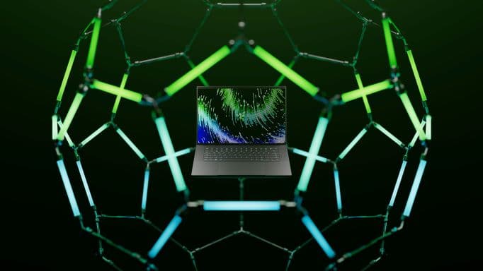 Laptop Razer Blade 16 au centre d'une structure géométrique de tubes luminescents vert et bleu sur fond noir