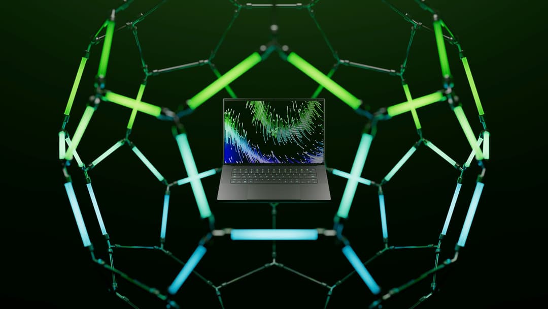 Laptop Razer Blade gris anthracite, écran affichant des graphiques colorés, entouré d'éléments géométriques verts et bleus sur fond noir