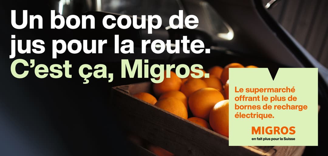 Campagne Migros montrant des oranges dans une voiture avec le slogan « Un bon coup de jus pour la route »