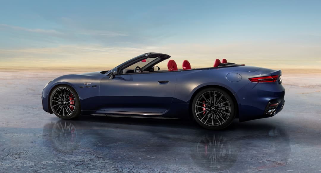Maserati GranCabrio bleu métallisé, cabriolet avec toit ouvert et intérieur rouge, photographié de profil sur une surface gelée