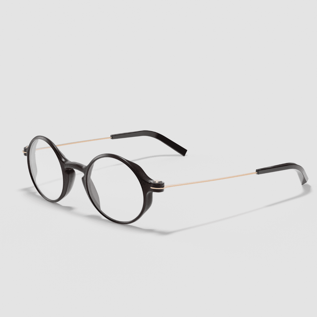 Lunettes VISAGES® à monture ronde noire et branche métal couleur cuivre, imprimées en 3D sur fond gris