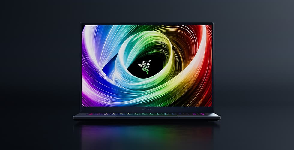 Razer Blade 16 ouvert affichant un écran avec motifs colorés tourbillonnants, logo Razer au centre, sur fond noir