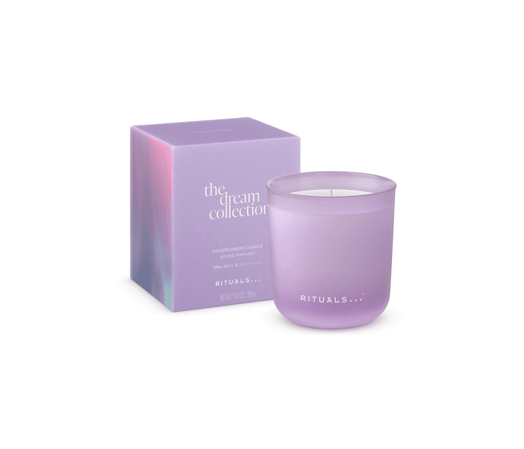 Bougie The Dream Collection de Rituals en verre teinté lilas avec sa boîte dégradé rose et mauve