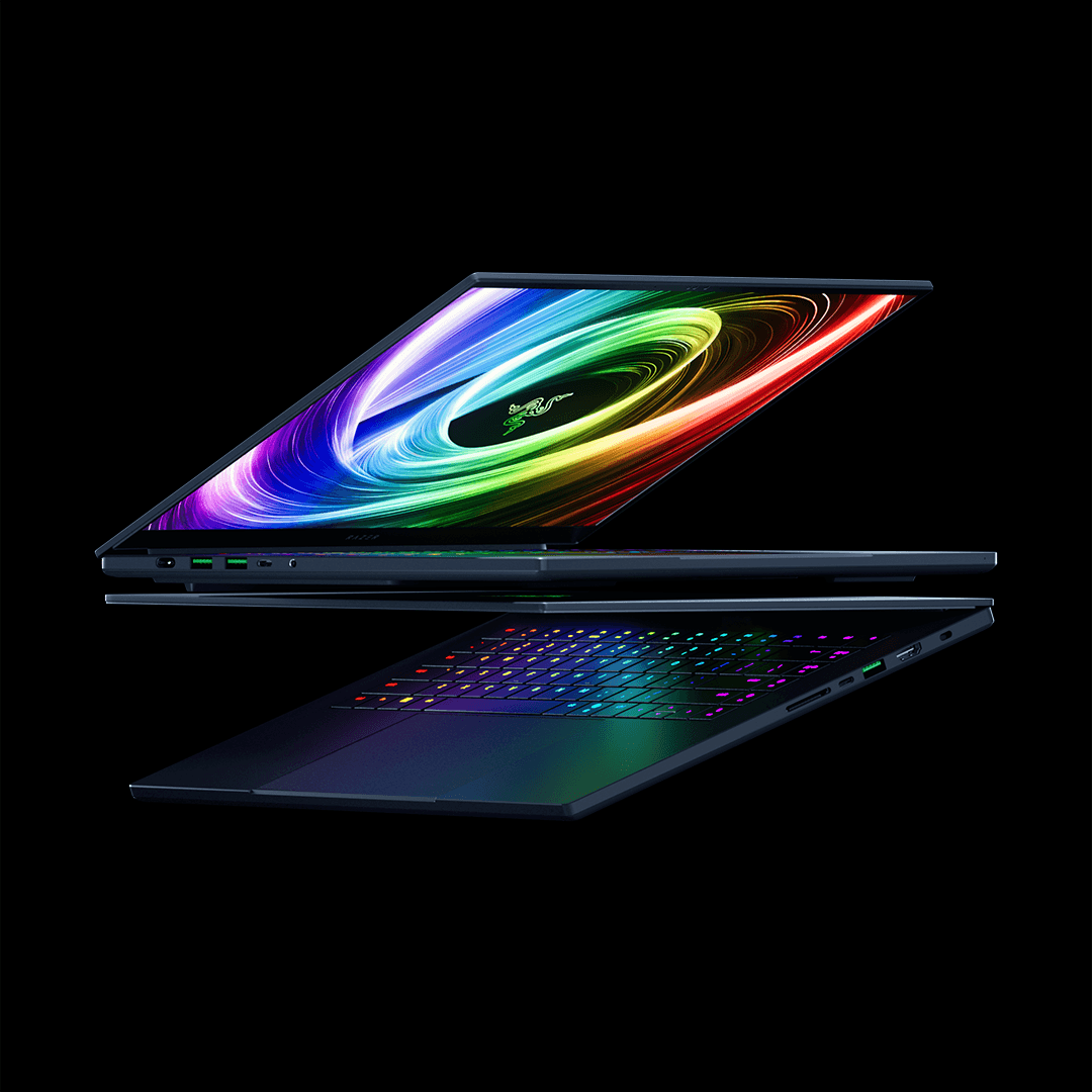 Razer Blade 18 ouvert de profil, écran affichant des vagues colorées multicolores, clavier rétroéclairé RGB sur fond noir