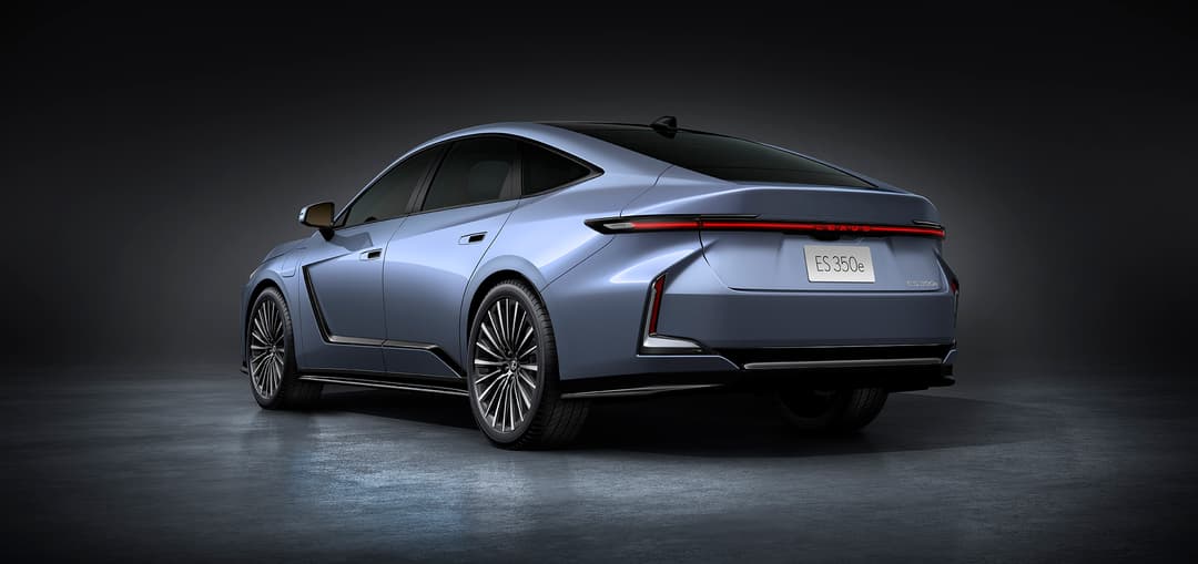 Lexus ES 350e gris argent photographiée de profil sur fond sombre, mettant en évidence son design épuré et ses feux arrière lumineux