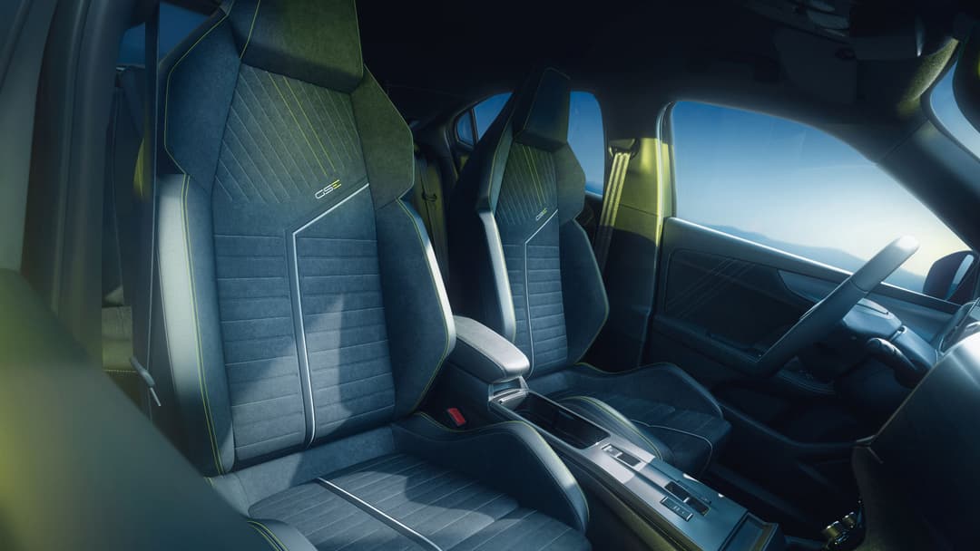 Intérieur du Mokka GSE avec sièges bleus à surpiqûres jaunes, volant plat et pédales sport en aluminium