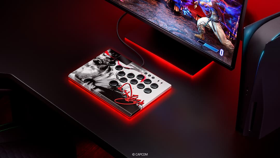 Razer Kitsune Édition Ryu, arcade stick aux couleurs noir et blanc avec motifs de Ryu, posé sur un bureau noir éclairé en rouge