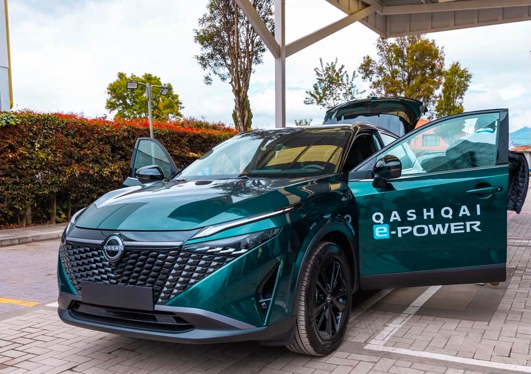 Nissan Qashqai e-POWER turquoise avec portière ouverte, présenté en extérieur sous un auvent
