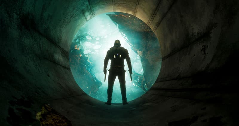 Peter Quill en silhouette face à une source lumineuse turquoise dans un tunnel sombre